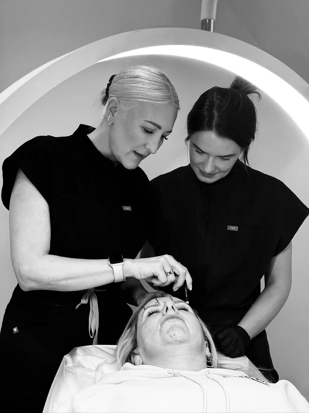 Two practitioners treating a client